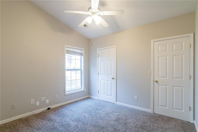 unfurnished room featuring carpet flooring, ceiling fan, and vaulted ceiling