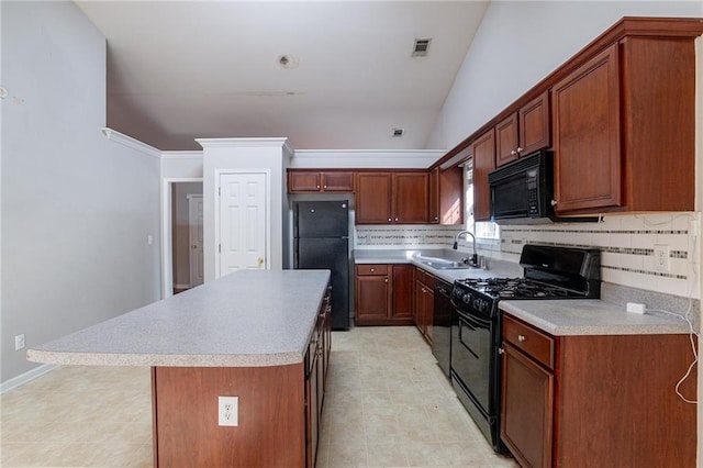 kitchen with sink, crown molding, decorative backsplash, a kitchen island, and black appliances