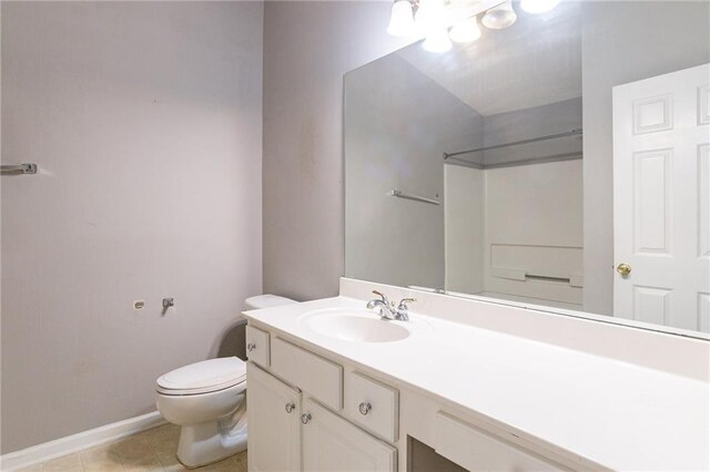 bathroom featuring toilet, vanity, and tile patterned floors