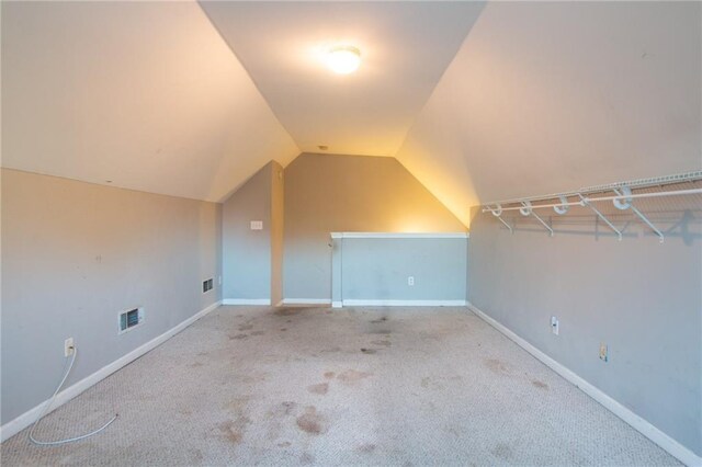 bonus room with light carpet and lofted ceiling