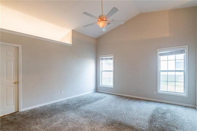 carpeted spare room with ceiling fan and high vaulted ceiling