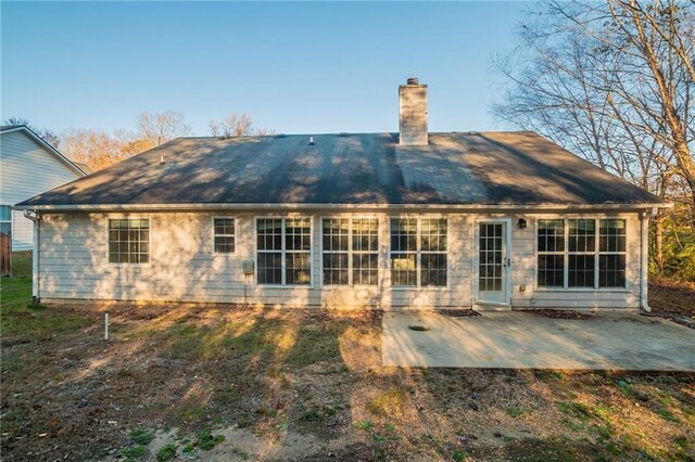 back of property with a patio