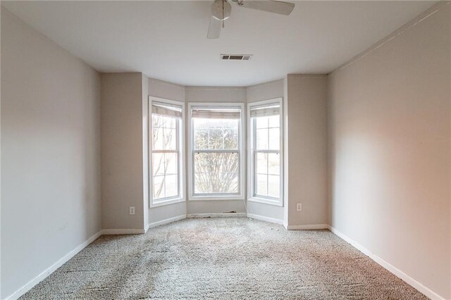 unfurnished room featuring ceiling fan and light colored carpet