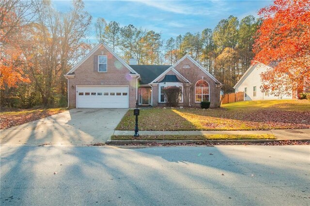 view of front of house with a garage and a front lawn