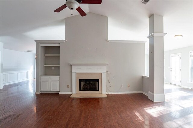 unfurnished living room with ceiling fan, built in features, wood-type flooring, and vaulted ceiling