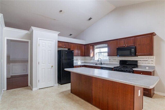 kitchen with backsplash, sink, a center island, and black appliances