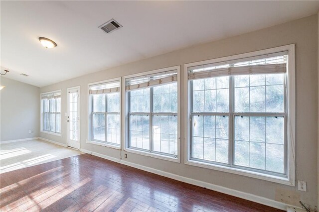 unfurnished room with hardwood / wood-style floors