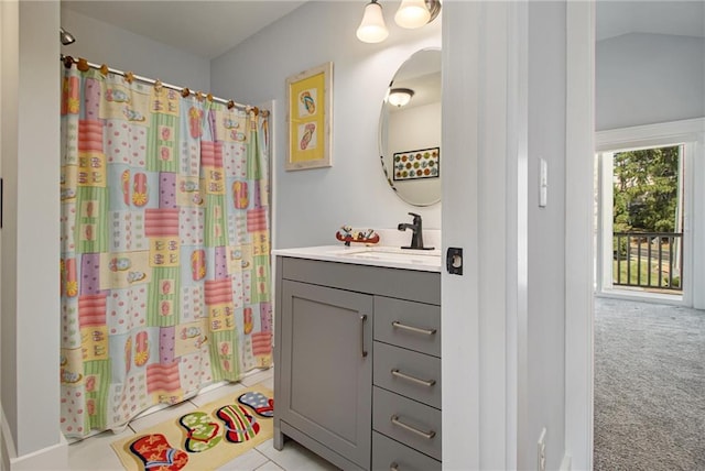 bathroom featuring vanity, vaulted ceiling, and a shower with shower curtain