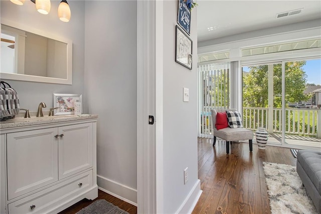 corridor with dark hardwood / wood-style floors and sink