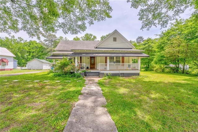 farmhouse-style home with covered porch and a front yard
