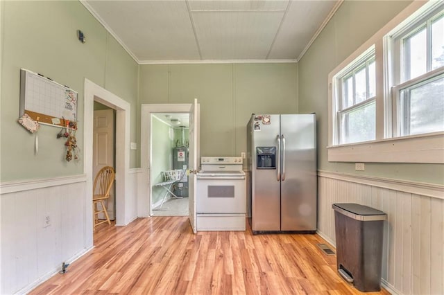 kitchen featuring stainless steel fridge, white range with electric stovetop, crown molding, light wood-style floors, and wainscoting