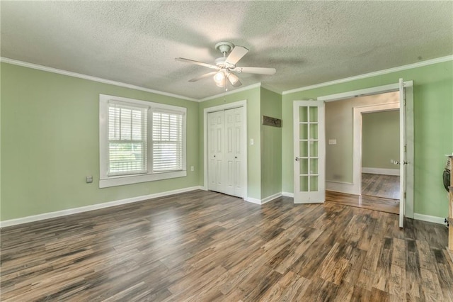 unfurnished bedroom featuring french doors, wood finished floors, crown molding, a textured ceiling, and a closet