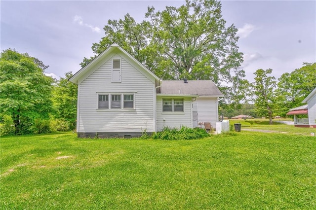 back of house with a yard and crawl space