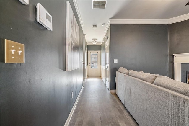 hall with hardwood / wood-style floors and ornamental molding