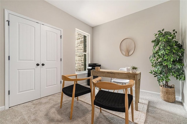 office area featuring light carpet