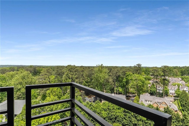 balcony with a residential view and a forest view