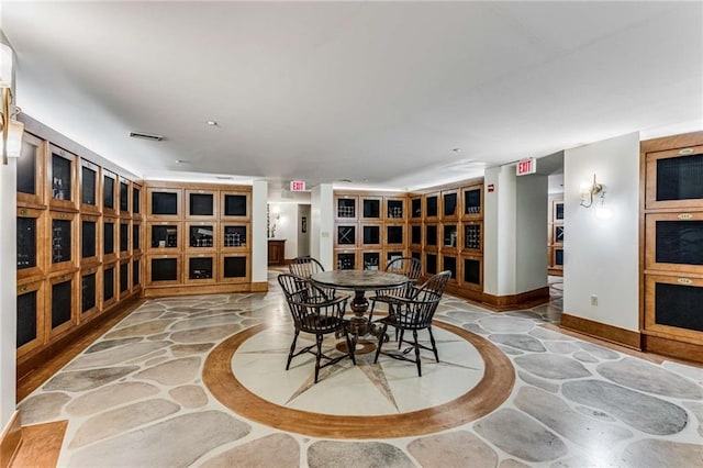 dining room with baseboards, stone floors, and visible vents