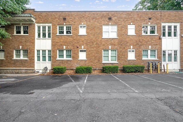 view of building exterior with uncovered parking