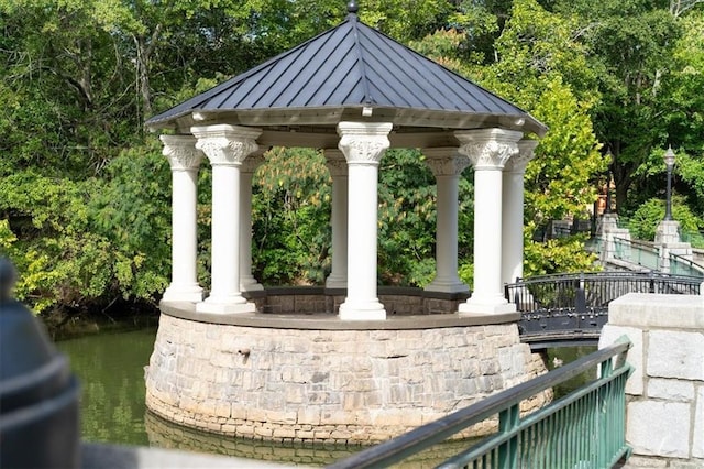 exterior space featuring a gazebo and a water view