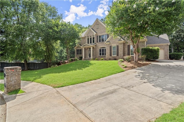 view of front of property with a garage and a front lawn