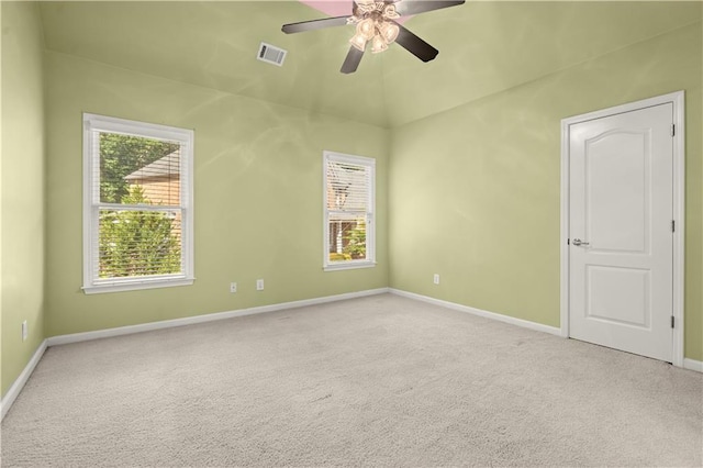 carpeted empty room featuring ceiling fan and a healthy amount of sunlight