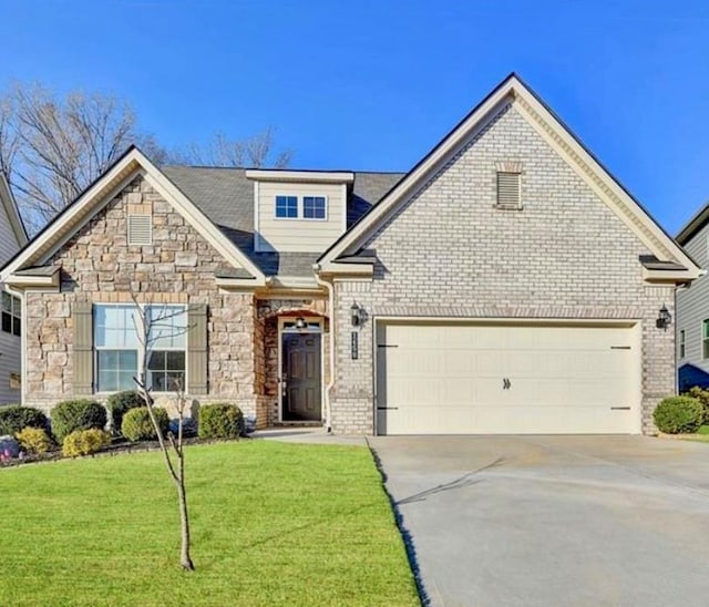 view of front of house featuring a front lawn, stone siding, concrete driveway, an attached garage, and brick siding