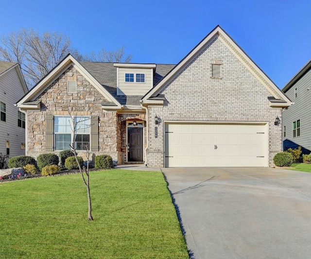 view of front of property with a front yard, an attached garage, concrete driveway, and stone siding