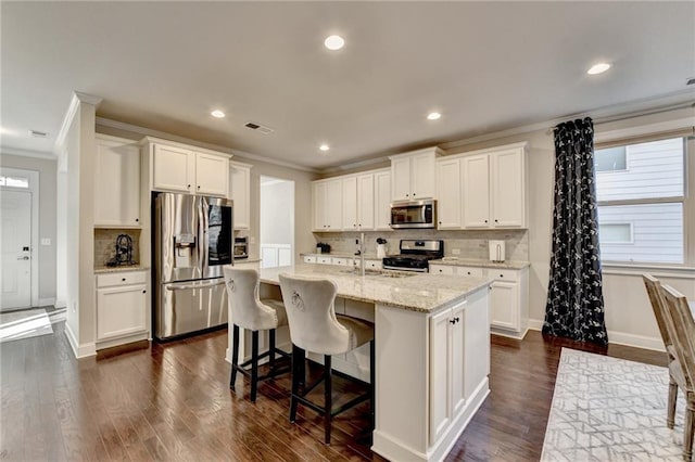 kitchen with crown molding, dark wood-style floors, visible vents, and stainless steel appliances