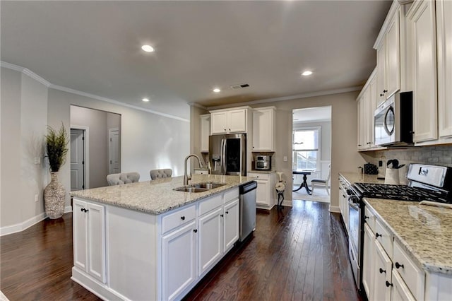 kitchen with dark wood-style flooring, appliances with stainless steel finishes, crown molding, and a sink