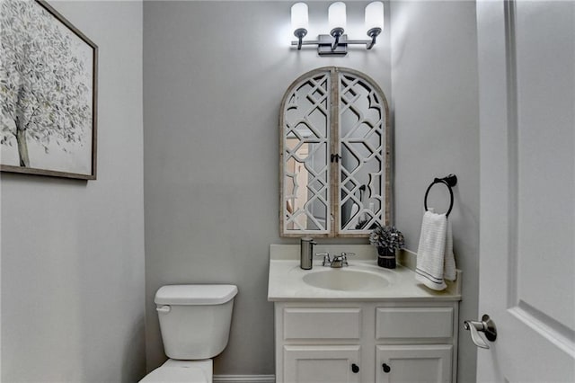 bathroom featuring toilet and vanity