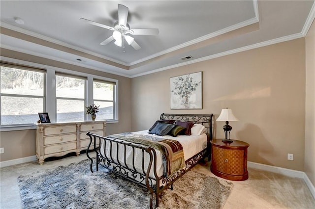 bedroom featuring visible vents, baseboards, carpet flooring, crown molding, and a raised ceiling