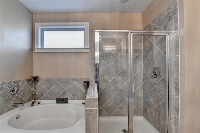 bathroom with a garden tub and a shower stall