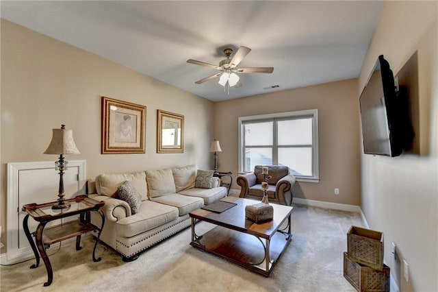 living room with visible vents, baseboards, light colored carpet, and ceiling fan