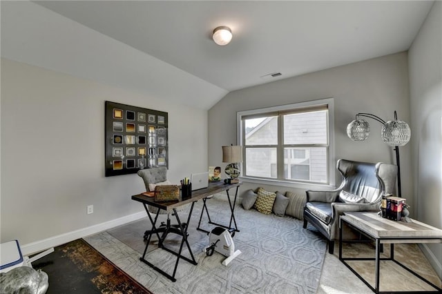 office space featuring visible vents, lofted ceiling, and baseboards