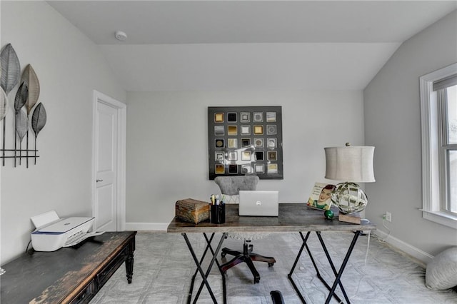 office with lofted ceiling, plenty of natural light, and baseboards