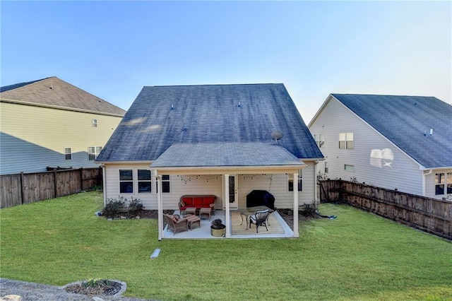 rear view of property with a yard, a patio area, a fenced backyard, and roof with shingles