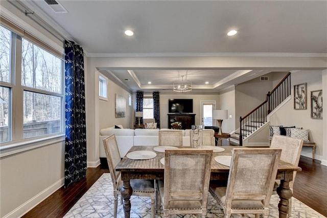 dining room featuring dark wood finished floors, visible vents, and ornamental molding