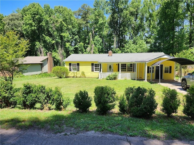 single story home with covered porch, a carport, and a front lawn