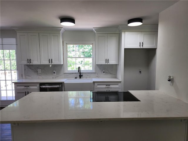 kitchen with black appliances, white cabinetry, backsplash, and light stone counters