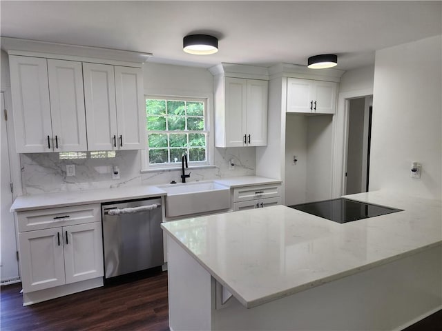 kitchen with white cabinets, dishwasher, decorative backsplash, and sink