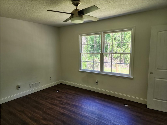 spare room featuring a textured ceiling, ceiling fan, and dark hardwood / wood-style floors