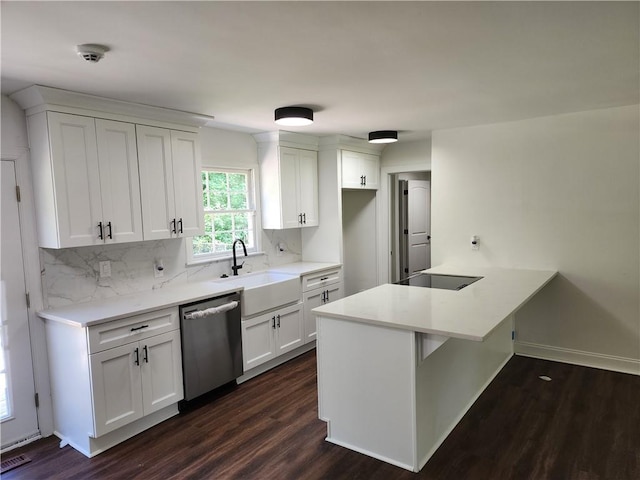 kitchen with dishwasher, tasteful backsplash, dark hardwood / wood-style flooring, white cabinetry, and sink