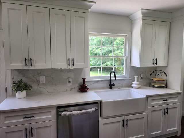 kitchen with sink, backsplash, white cabinets, and dishwasher