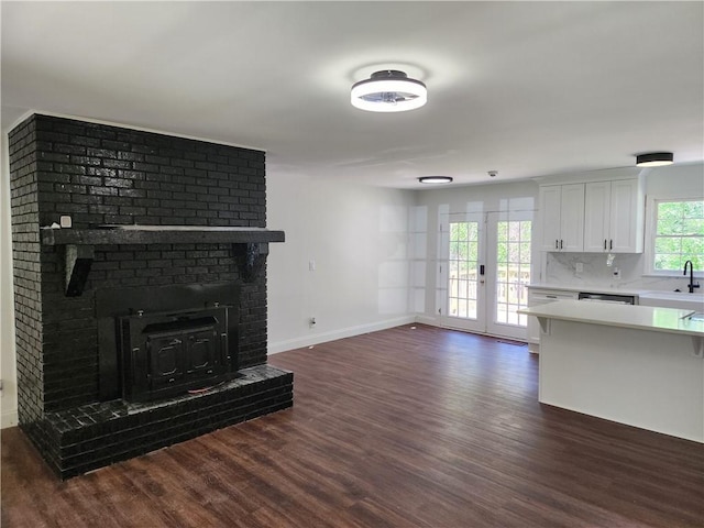 living room featuring sink, dark hardwood / wood-style flooring, and french doors