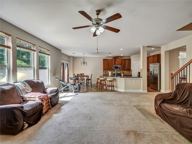 living area featuring recessed lighting, a ceiling fan, stairs, and light carpet