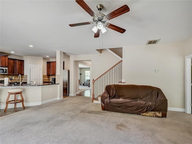 living area with ceiling fan, light carpet, visible vents, and recessed lighting
