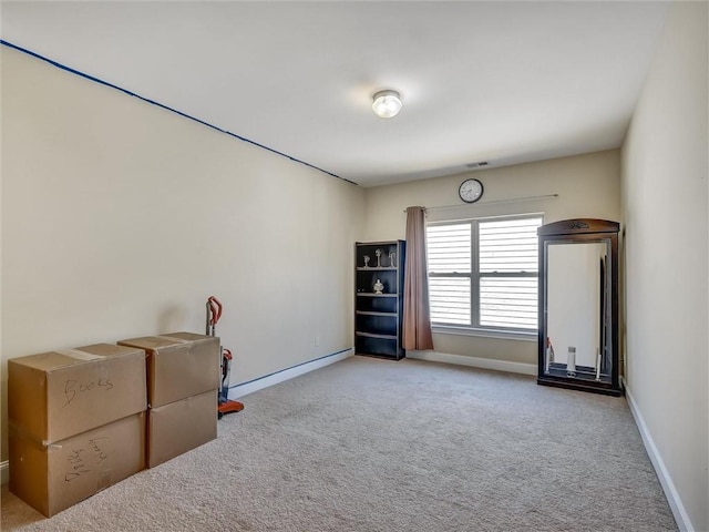 interior space featuring visible vents, baseboards, and carpet floors