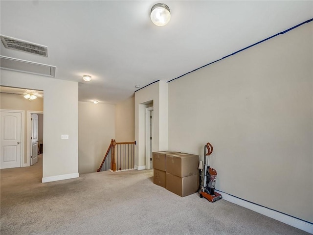 basement with baseboards, visible vents, and carpet floors