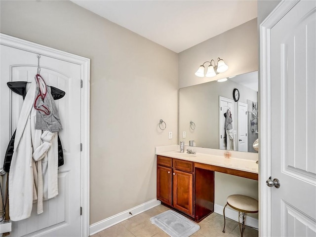 bathroom with vanity, tile patterned flooring, and baseboards