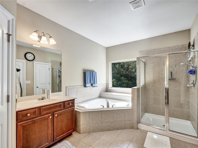 bathroom featuring visible vents, tile patterned flooring, a shower stall, a garden tub, and vanity